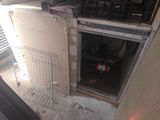a small refrigerator that is in the corner of a room