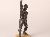 a bronze statue of a man lifting a barbell on a marble base