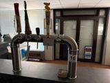 a picture of a counter with a bunch of beer taps on it