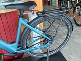 a blue bicycle that is on display in a shop