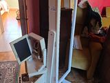 a computer on a stand in the middle of a living room
