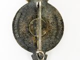 an image of a metal pin with a sword on it