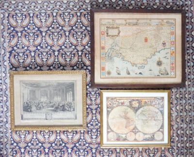 three framed maps on the wall of a room