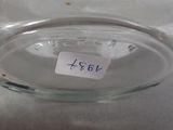 a glass vase with a label on it on a table
