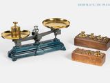 Trois types de balances différents sont représentés sur une surface blanche