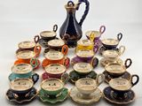 a lot of cups and saucers sitting on a table