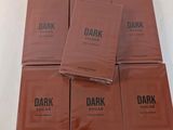 six packs of dark sugar chocolate sitting on top of each other