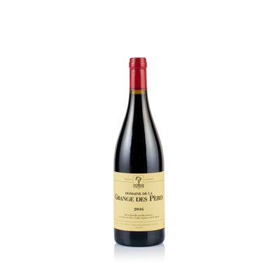 a bottle of red wine sitting on top of a white table