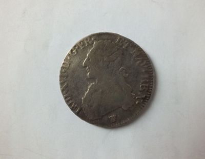 a close up of a coin on a table with a white background