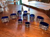 a table with a bunch of blue glass bowls on it