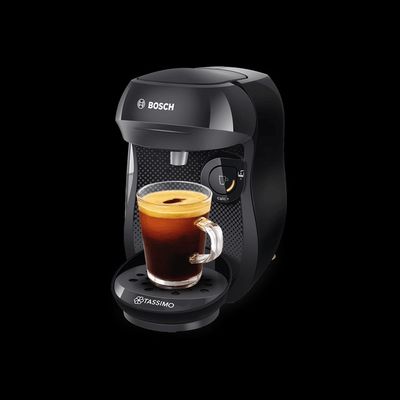 the coffee maker is next to a cup of coffee