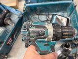 a person holding a cordless drill in their hand