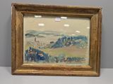 une photo représentant un tableau représentant un paysage, dans un cadre doré, posé sur une table