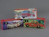 three boxes of toy cars sitting on top of a gray surface