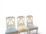 three chairs with a blue cushion and a white background