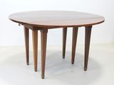 an image of a round table with four legs and a wooden top