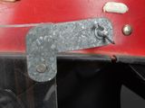 a close up of a metal object on a red surface