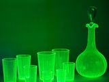 a lot of glasses and a decanter sitting on a table