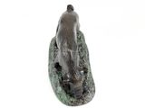 a statue of a bear that is sitting on a rock