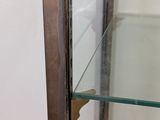 a glass display case with a broken glass door