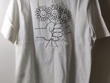 white t - shirt with a drawing of a man holding a bouquet of sunflowers