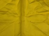 a close up of a yellow cloth with a white background