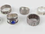several different types of rings on a white surface
