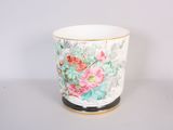 a white cup with a floral design on it