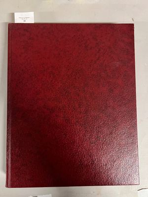 a red binder with a white label on it
