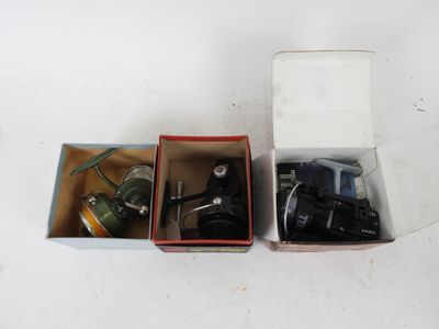 two boxes that have different types of fishing reels in them