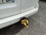 a banana sitting on the ground next to a car