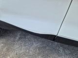 a white car that is parked on the side of the road