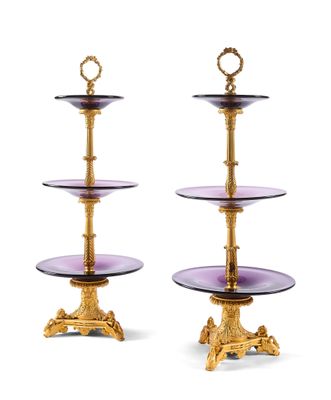 two tiered glass cake stands with gold trimmings and a purple glass plate