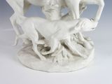 a statue of a man riding a horse with two dogs