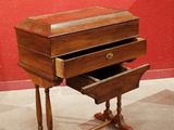 a small wooden desk with two drawers on it