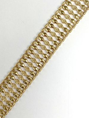 an image of a close up of a gold bracelet on a white surface