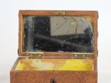 a small wooden box with a mirror inside of it