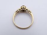a close up of a gold ring on a white surface
