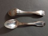 two spoons that are sitting on a table