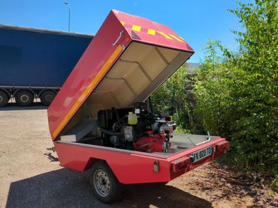 a red truck with a red engine in the back of it
