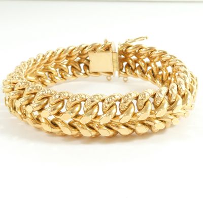 a gold bracelet with a chain link and a clasp