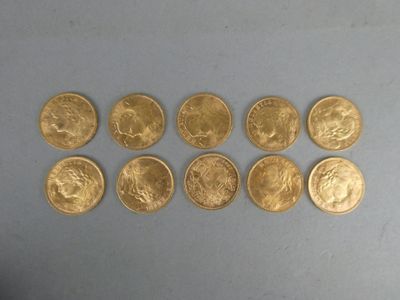 a close up of a bunch of gold coins sitting on top of a table