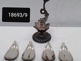 silver plated spoons and spoon spoons are arranged on a table