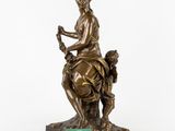 a bronze statue of a woman sitting on a horse