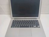 a silver laptop computer sitting on a white table