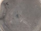 a close up view of a silver plate with a hole in it
