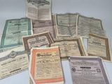 several old certificates are stacked on top of each other on a table