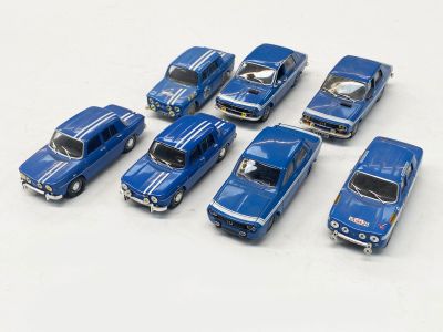 plusieurs petites voitures sont alignées sur une surface blanche