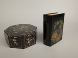 pair of black lacquered boxes with floral designs on them