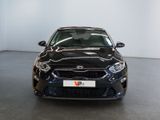 the front view of a black car parked in a showroom